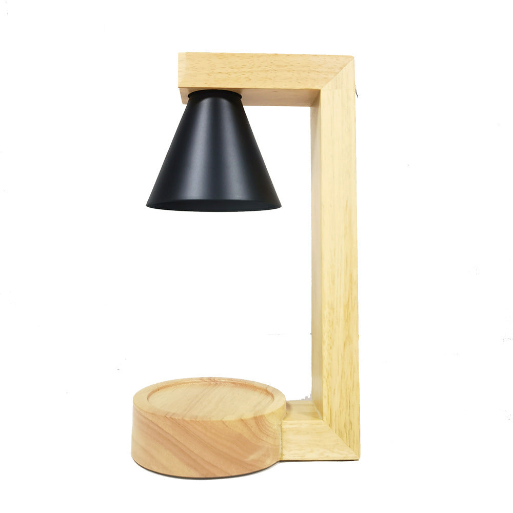 A Japanese style melting wax lamp with a white hood on a bamboo wood base, surrounded by various decor items on a table. Table lamp. Home Decor. Wax lamp.
